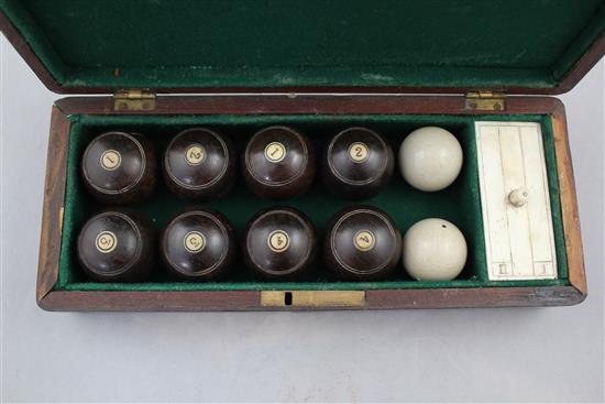 A mahogany cased set of indoor carpet bowls, 9.75in.